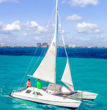 side view of small catamaran with blue sea behind